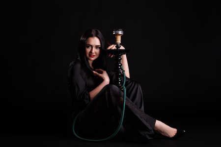 Sexy young girl in black dress with hookah Khalil Mamoon.の写真素材