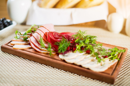 meat delicatessen plate with pomegranate, dill and parsley.の写真素材