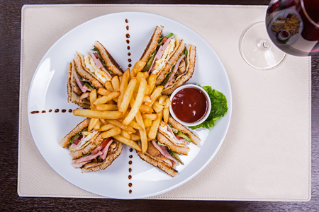 Four sandwiches on the plate with french fries.の写真素材