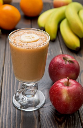 Fruit smoothie in a glass on wood.の写真素材
