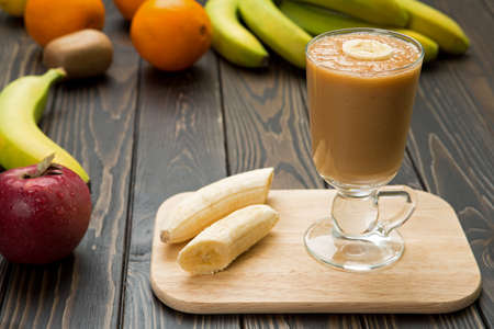 Fruit smoothie in a glass on wood.の写真素材