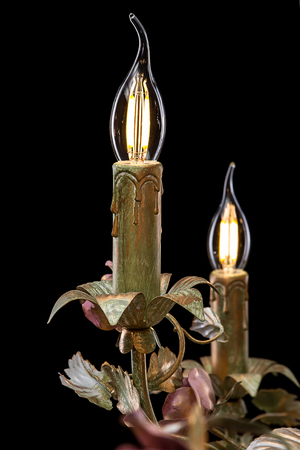 Chandelier close-up classic bronze with curly lampshades flowers and gold leaves.の写真素材