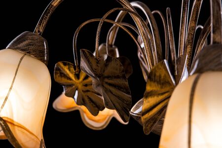 Chandelier light in interior closeup on black backgroundの写真素材
