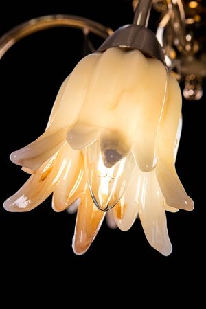 Chandelier light in interior closeup on black backgroundの写真素材