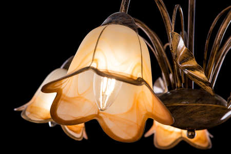 Chandelier light in interior closeup on black backgroundの写真素材