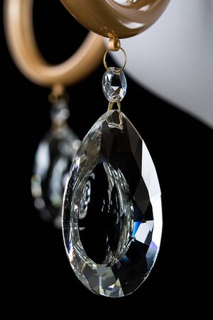 Chandelier light in interior closeup on black backgroundの写真素材