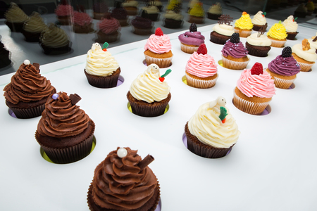 colorful cupcakes with different Tastes. Small beautifull cakes on white table top.の写真素材