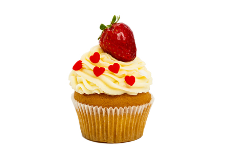 creamy sweet cupcake with a strawberry on the top on a white background.の写真素材