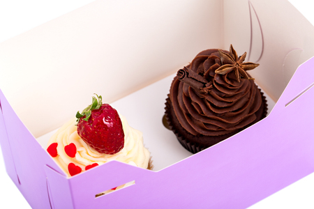 Two Cupcakes are in the Delivery Box over white backgroundの写真素材
