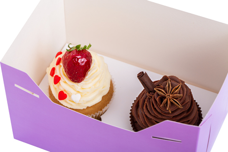 Two Cupcakes are in the Delivery Box over white backgroundの写真素材
