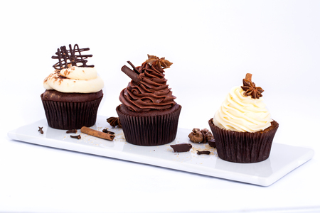 Three Chocolate sweet cupcakes on a white backgroundの写真素材