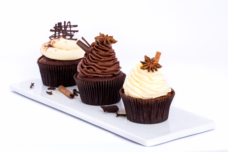 Three Chocolate sweet cupcakes on a white backgroundの写真素材
