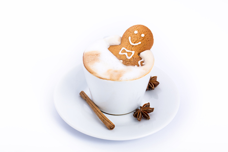 Gingerbread man inside coffee cup isolated on whiteの写真素材