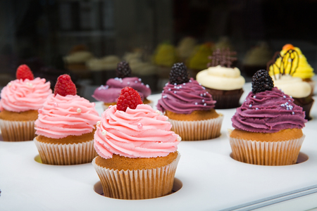 colorful cupcakes with different Tastes. Small beautifull cakes on white table top.の写真素材