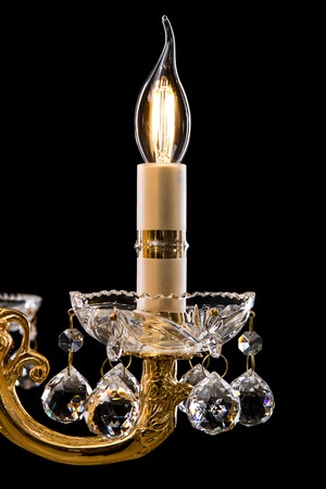 Contemporary gold chandelier isolated on black background. close-up . Crystal chandelierの写真素材