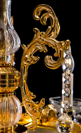 Contemporary gold chandelier isolated on black background. close-up . Crystal chandelierの写真素材