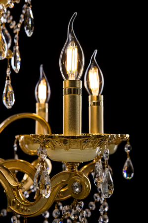 Contemporary gold chandelier isolated on black background. close-up . Crystal chandelierの写真素材