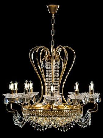 Contemporary gold chandelier isolated on black background. Crystal chandelierの写真素材