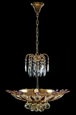 Contemporary gold chandelier isolated on black background. Crystal chandelier decorated purple crystalsの写真素材