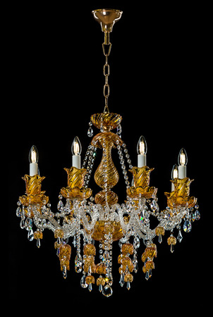 Contemporary gold chandelier isolated on black background. Crystal chandelierの写真素材