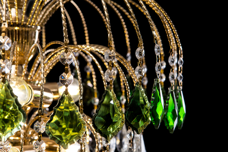 Chandelier for interior of the living room. chandelier details decorated green crystals isolated on black background.の写真素材