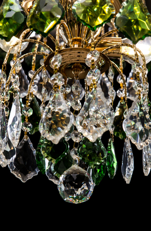 Chandelier for interior of the living room. chandelier details decorated green crystals isolated on black background.の写真素材