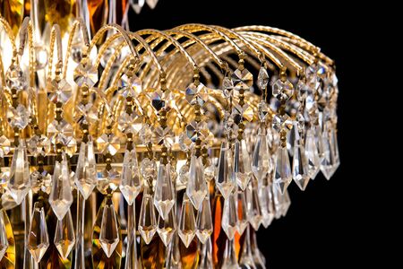 Large crystal chandelier close-up in baroque style isolated on black background. Luxury royal expensive chandelier for living room, Hall of celebration.の写真素材