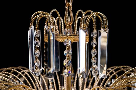 Large crystal chandelier close-up in baroque style isolated on black background. Luxury royal expensive chandelier for living room, Hall of celebration.の写真素材