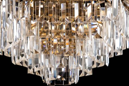 Large crystal chandelier close-up in baroque style isolated on black background. Luxury royal expensive chandelier for living room, Hall of celebration.の写真素材
