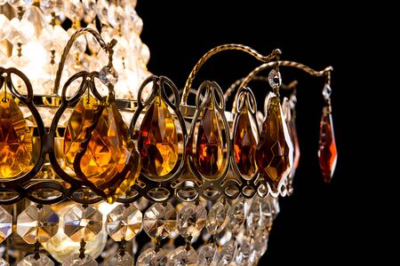 Large crystal chandelier close-up in baroque style isolated on black background. Luxury royal expensive chandelier for living room, Hall of celebration.の写真素材