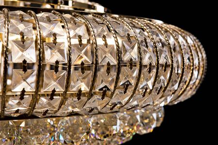 Large crystal chandelier close-up in baroque style isolated on black background. Luxury royal expensive chandelier for living room, Hall of celebration.の写真素材