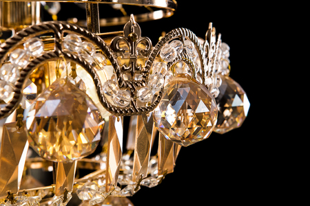 Large crystal chandelier close-up in baroque style isolated on black background. Luxury royal expensive chandelier for living room, Hall of celebration.の写真素材