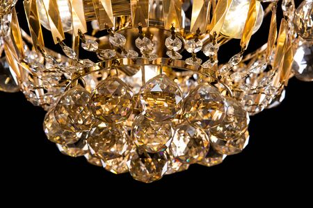 Large crystal chandelier close-up in baroque style isolated on black background. Luxury royal expensive chandelier for living room, Hall of celebration.の写真素材