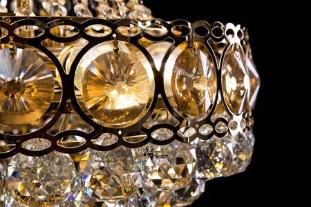 Large crystal chandelier close-up in baroque style isolated on black background. Luxury royal expensive chandelier for living room, Hall of celebration.の写真素材