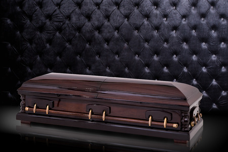 closed wooden brown sarcophagus isolated on gray luxury background. casket, coffin on royal background.の写真素材
