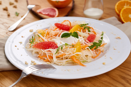 Fresh healthy salad with cabbage, carrot, citrus and yogurt.の写真素材
