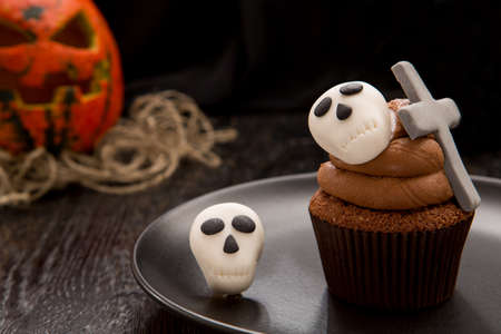 Halloween cupcake with tombstone cross and skulls.の写真素材