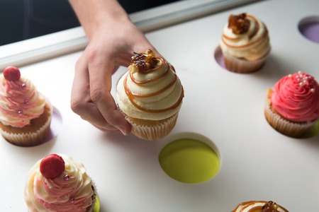 colorful cupcakes with different Tastes. Small beautifull cakes on white table top.の写真素材