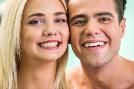 Beautiful woman and man smile. Teeth after whitening. Dental health background.の写真素材