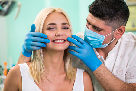 Dentist and orthodontist concept. Woman smile showing her white teeth,の写真素材