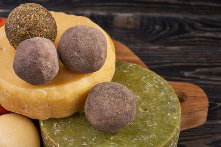 platter with different types of cheese. Handmade cheese on wooden board. cheese productionの写真素材