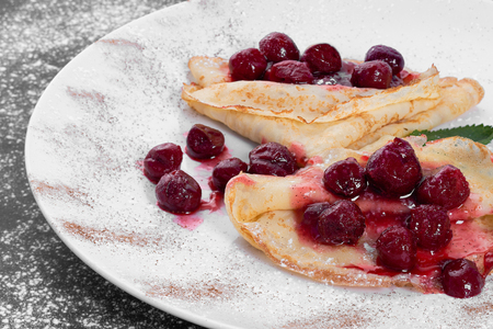 Delicious pancakes with honey served with cherriesの写真素材