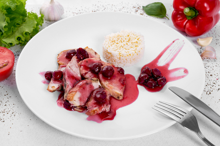 Turkey medallions in cherry sauce with rice.の写真素材