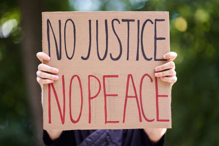 Kiev, Ukraine - July 31 2020: No justice no peace poster which person is holding. Stop racism...