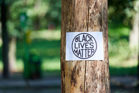 Kiev, Ukraine - July 31 2020: Black Lives Matter inscription in circle on tree. Stop racism concept. Black Lives Matter protest sign. Action against discrimination by skin color.のeditorial素材