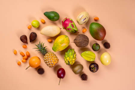 Fresh fruits background. Juicy fruits. Mixed tropicak fruits on beige background. Advertisement...