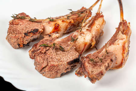 Lamb ribs with thyme and adjika on a white plateの写真素材