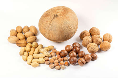 Coconut, macadamia, pecan, walnuts, peanuts and hazelnuts on whiteの写真素材