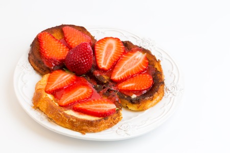 Breakfast French toast with strawberries isolated on white backgroundの写真素材