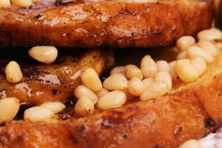 French toast with honey syrup croutons pine nuts breakfast sweet dessert selective soft focusの写真素材